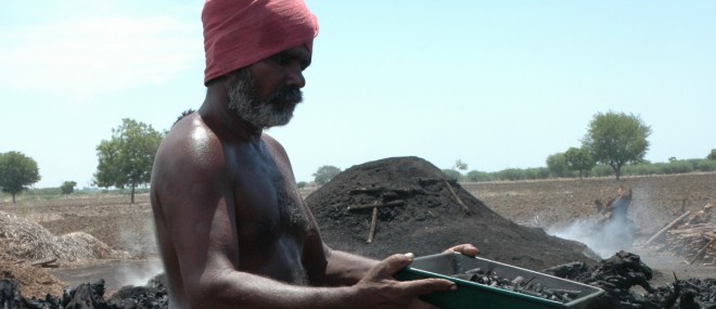 Man making biochar to capture carbon and promote organic agriculture 