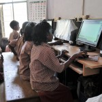 Children at a SCAD school learning how to use computers